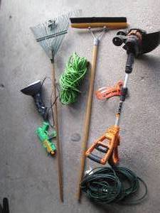 lot 138 image: Yard lot including extension cords, Worx trimmer with no battery, clamp light and more