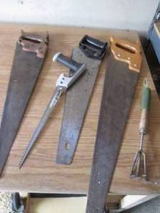 lot 144 image: Hand saws and a garden trowel...
