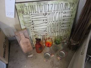 lot 235 image: Large Wood Tuscan Style wall decor with Wine bottle shaped cutting board, Colored glass stemware, Grapevine coffee mugs and stalks of grapevine and bamboo