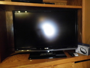lot 195 image: Large Sharp flat-screen TV with remote