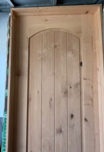 lot 20 image: 24  Arched unfinished right hung pre-hung door knotty alder