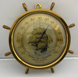 lot 85 image: Vintage Brass Ships Wheel Thermometer With Michell Sales Corpporation Advertisement