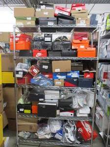 lot 733 image: Rack of over 50 pairs of authentic name brand shoes - these shoes were bought from big box retail stores and outlets.  Some may have signs of wear and blemishes. Low reserve of 900.00