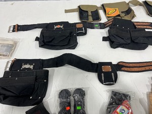 TABLE FULL OF TOOL BELTS, TOOL BELT ATTACHMENTS, & STORAGE POUCHES