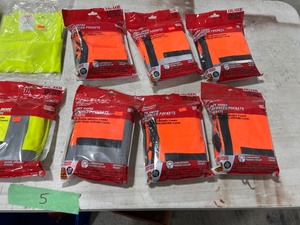 TABLE FULL OF SAFETY PANTS & VESTS
