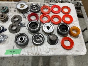 TABLE FULL OF WHEELS, FLANGES, & BEARINGS