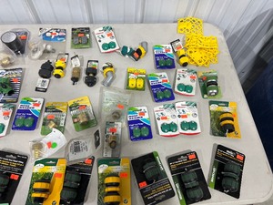 TABLE FULL OF HOSE FITTINGS AND ATTACHMENTS