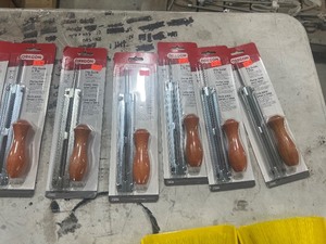TABLE FULL OF CHAINSAW SHARPENING TOOLS