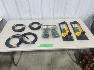 TABLE FULL OF SPRINKLERS, HOSE, FLOODLIGHTS