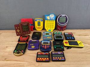 lot 142 image: (17) Assorted Handheld Electronic Games - Connect Four, The Simpsons, Battleship, Pac-Man, Scrabble, Vegas-Style Games, and more E