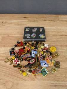 lot 131 image: An Assortment of Pins including M&Ms  E