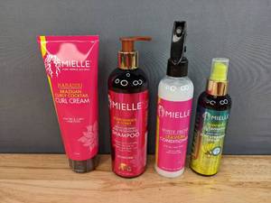 lot 62C image: Brand New Mielle Babassu Brazilian Curl Cream, Pomegranate & Honey Shampoo, White Peony Leave-In Conditioner, Acocado & Tamanu Stay Straight Serum Retail Value $58.31 I