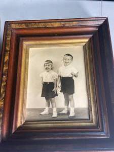 lot 75 image: Vintage Framed Black-and-White Photograph of Children with Collectible Newspaper Comics Section