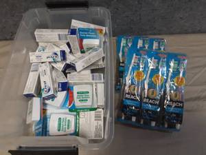 Small Tote of Floss, Tooth Paste, and Tooth Brushes