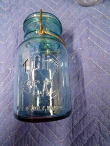 lot 12 image: 2 Vintage green and 1 clear canning jars with glass lids