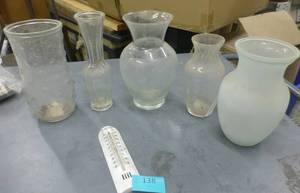 5 flower vases and a thermometer