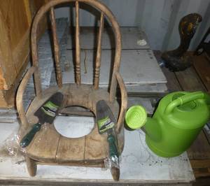 Vintage childrens wood potty chair for flower pots and garden shovels and waterer