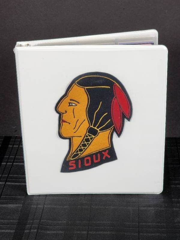 lot 288 image: Vintage TV Show Collectable Cards with a University of North Dakota Fighting Souix Patch