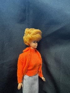 lot 38 image: Vintage Bubblecut Barbie Wearing Sweater Girl Outfit