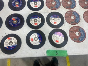 Table full of metal cut off wheels 6 12 and 6 inch