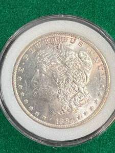 lot 96 image: 1884-O US MORGAN SILVER DOLLAR IN GREEN CASE