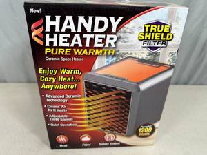 lot 199 image: New Handy Heater Pure Warmth Ceramic Space Heater with LED Lights