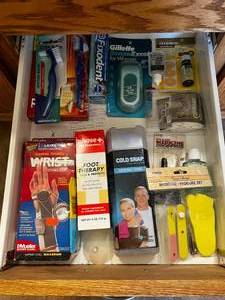 lot 252 image: Contents of Bath Drawer Inc In Pkg Razor, Various Foot Care, Used Nail Polish, First Aid Bandages & More