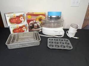 lot 337 image: West Bend Steamer w Trays, Coffee Grinder Krups, Muffin Tin, Stackable Baking Pans, 2 Dip Bowl Spreader Sets, Nordic Ware Bundt Pan