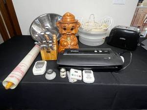 lot 327 image: 2 Slice Toaster (untested), Round Tupperware Containers (1 handle), Smokey the Bear Cookie Jar, Food Saver (all parts unverified), Digital Timers, Countersaver, Cutlery Set Missing 2 Knives, Large Mixing Bowl