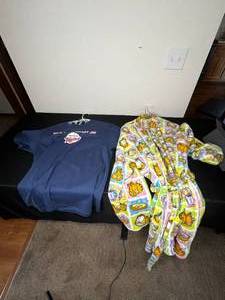 lot 405 image: Lot of Closet Contents Inc Twins Joe Mauer T-Shirt Sz Lg, Garfield Robe, Islands of Adventure Universal Denium Jacket Sz XL, Knit Hangers & More