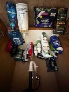 lot 253 image: Contents Under Bath Sink Inc Cleaning Supplies, Unopened Lotion & Shampoo, Air Freshener, Unopened Wipes & More