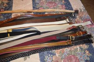 Assorted Belts and Suspenders with Small Suitcase