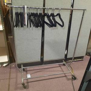 Rolling coat rack with hangers. Measures 50 L x 22.5 D X 56 H.