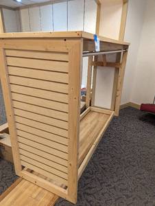 Heavy duty Wood framed retail display with slatted shelf top and end for additional usage space