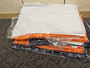 Large stack of White, Navy and Orange gift wrapping tissue