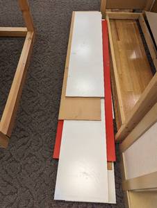 Bundle of wood and melanine board shelving planks in 4,5,and 6 ft lengths