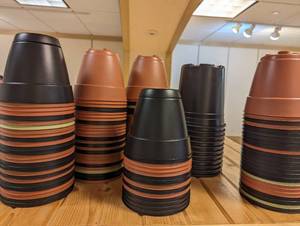 Multiple stacks of assorted flower pots