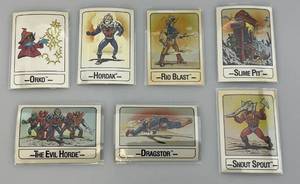 lot 112 image: 1986 MOTU Trading Cards (In Protective Sleeves)