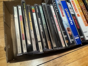 lot 21 image: Assortment of DVDs and CDs including Despicable Me, Spider Man, Dr Dre, Usher, LL Cool J and more