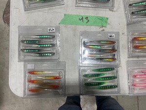 TABLE FULL  OF FISHING PLASTICS AND TRILENE LINE