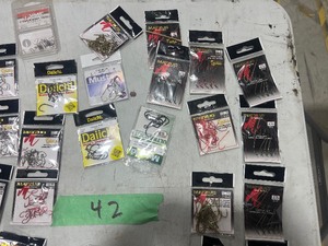 TABLE FULL OF FISHING LINE & A VARIETY OF HOOKS