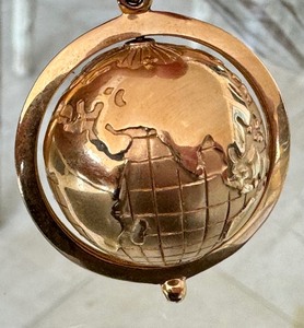 lot 20A image: 14k Gold Rotating Globe Pendant