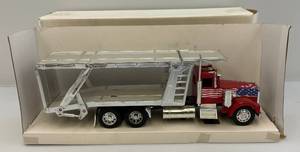 lot 217 image: 132  Scale Die-Cast Kenworth W900 Auto Carrier WFlag (Pre-Owned Displayed With Original Box)