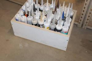 lot 985 image: Lot of (49) Assorted Sealants with Wooden Storage Box - Window & Door, Fire Barrier, Baseboards and more