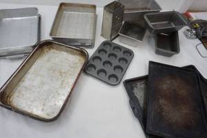 lot 208 image: Kitchen Items Cheese Grater, Bread Pans, cake Pan, Cookie sheets
