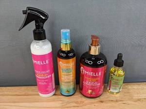 lot 75A image: (4) Brand New Mielle Hair Products (White Peony Leave-In Conditioner, Mango & Tulsi Nourishing Thermal Protectant Spray, Pomegranate & Honey Leave in Conditioner, Light Rosemary Mint Scalp & Hair Strengthening Oil) Retails for $50.00 I