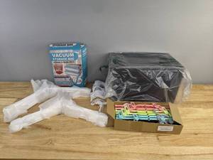lot 72 image: Assorted White and Multicolor Hangers, Vacuum Storage Bags, and 2-Pack Bino Grids Q