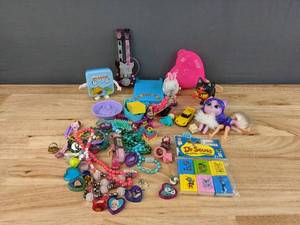 lot 113 image: An Assortment of Toys includes Dr. Seuss, Figurines, Beads, and more E