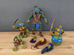 lot 61 image: Collection of Teenage Mutant Ninja Turtles Toys (McDonalds, Singular Walkie-Talkie, Action Figures, and more) E