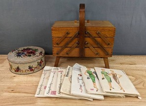 lot 134 image: Beautiful Vintage Oak Accordion Sewing Box, Various Vintage Patterns, and Tin Filled w Sewing Supplied. Hamms, Simplicity, Butterick, McCalls E